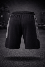 Athlete wearing men training shorts during gym workout session