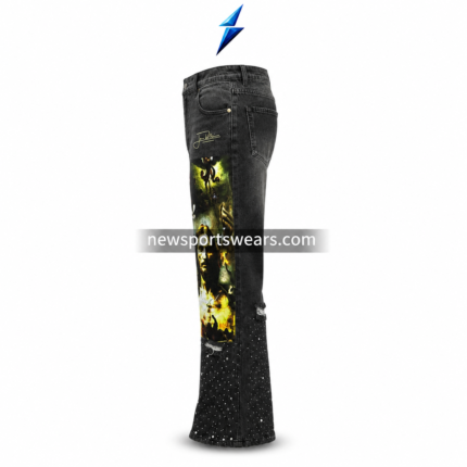 Black graphic jeans with washed denim texture, cross print, portrait artwork, distressing, and rhinestone-style lower-leg details