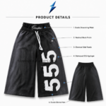 NEW SPORTS WEAR Baggy Shorts close-up showing three distressed white 555 appliqués on the black NSW leg panel