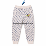NEW SPORTS WEAR cream and navy joggers featuring an angled pocket, reinforced stitching and colorful thigh patch.