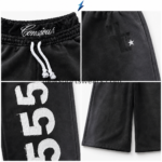 NSW Baggy Shorts waistband close-up with multi-row elastic, white rope drawstring and NEW SPORTS WEAR graphic detailing