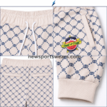 NSW Custom Jogger Pants front view in cream and navy with all-over print, drawstring waist, side pockets and thigh logo.