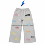 NSW Men’s Graphic Sweatpants front view in grey with multicolor leg prints, black thigh lettering and yellow pocket patch