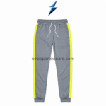 NSW New Sports Wear Men’s track pants in grey with neon-yellow side stripes, front view