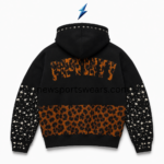 NSW black rhinestone hoodie back with orange appliqué lettering, studded sleeves and patterned lower panel